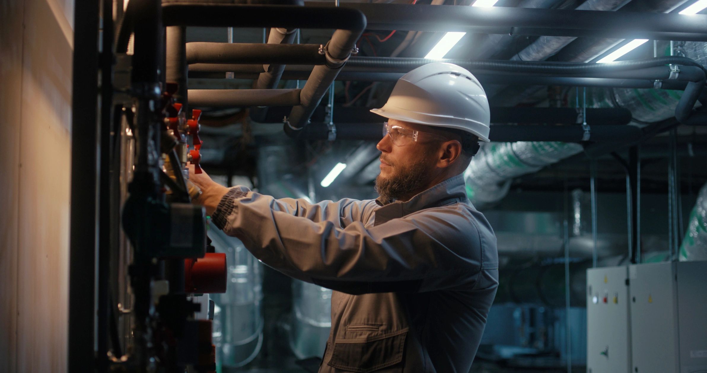 Worker checking a pipeline system