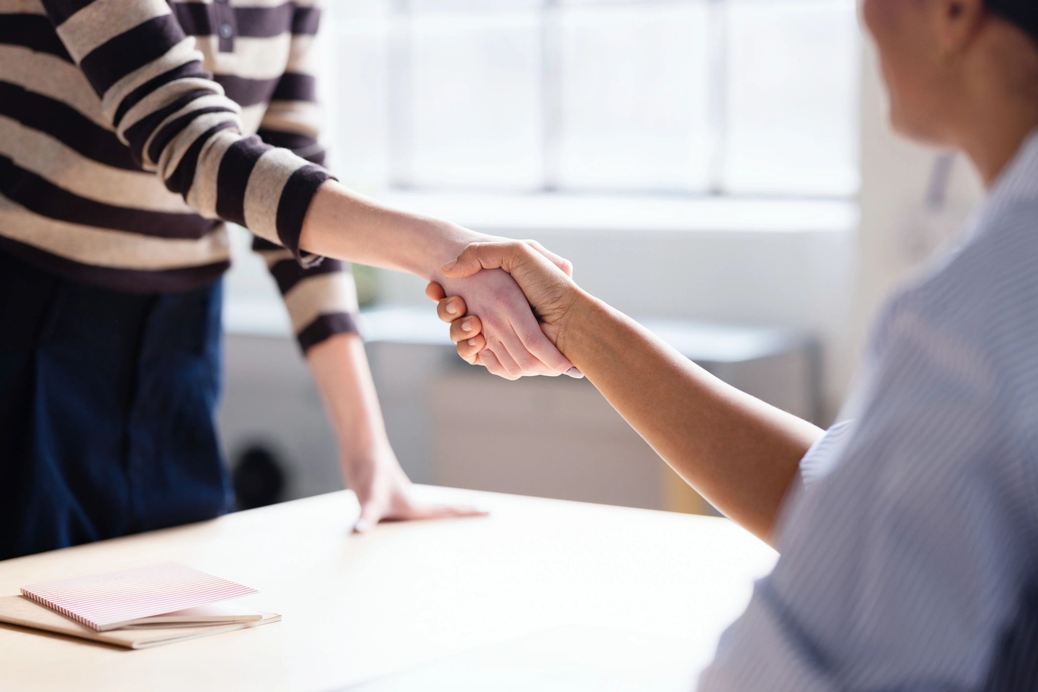 Customer service handshake representing trust and satisfaction